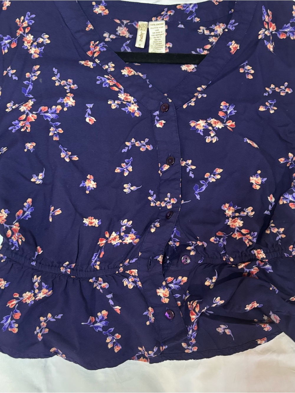 JAPNA Navy Floral Peplum Blouse V-Neck Button Front Long Sleeve peplum shape.